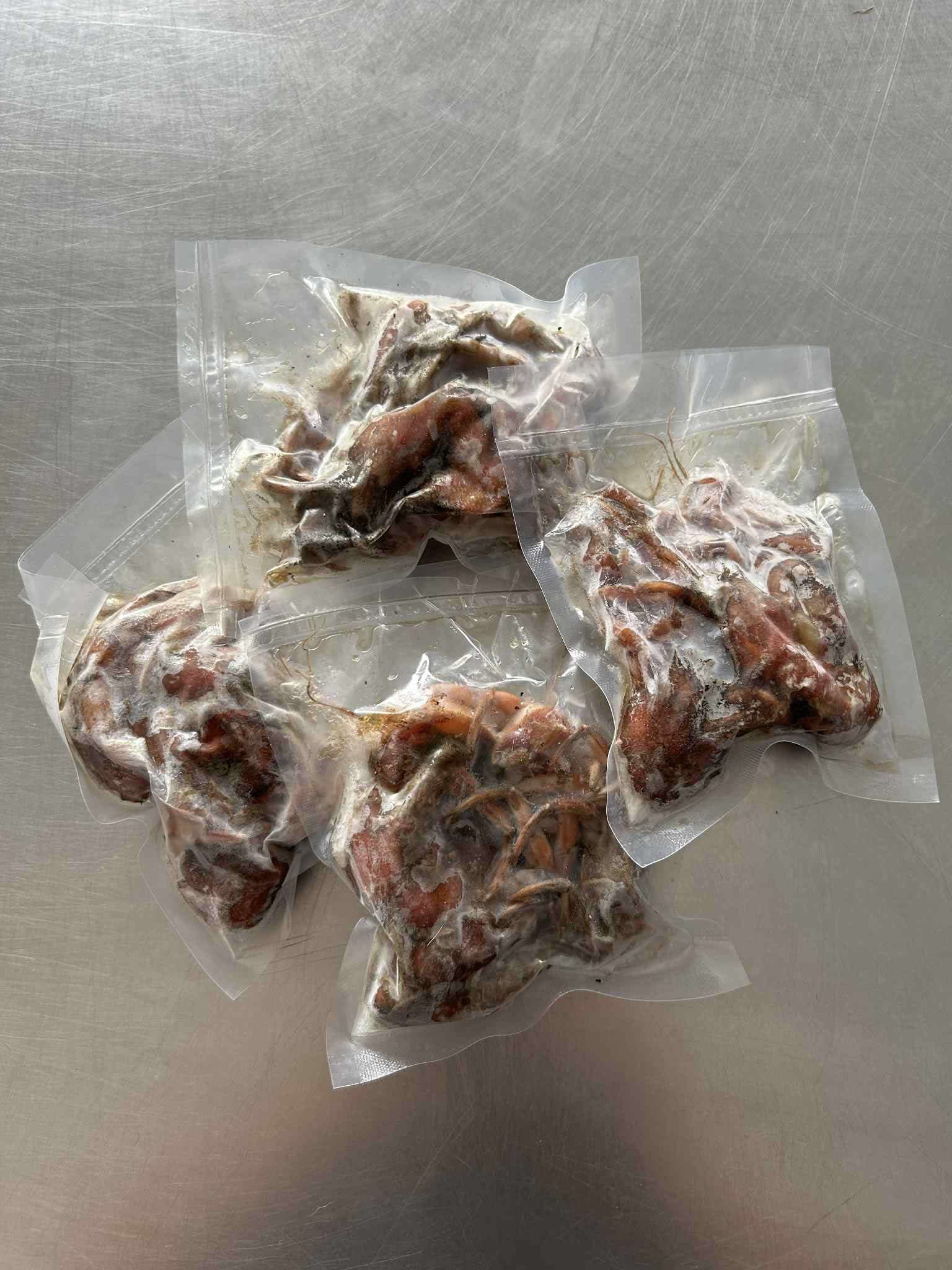 Clear package of frozen hermit crab bait, prepared and ready to use for sea fishing